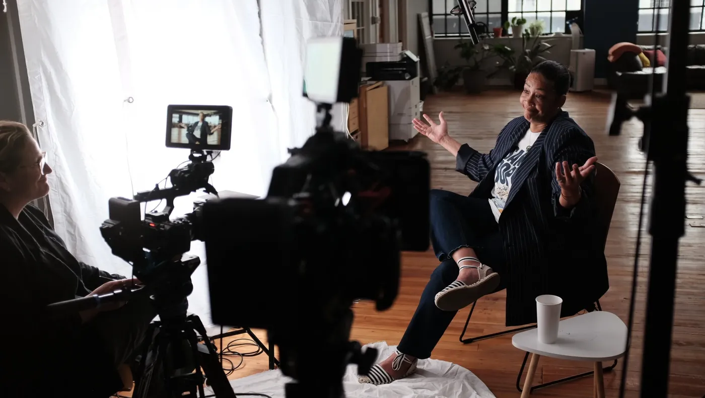 An interviewee gestures while speaking on camera